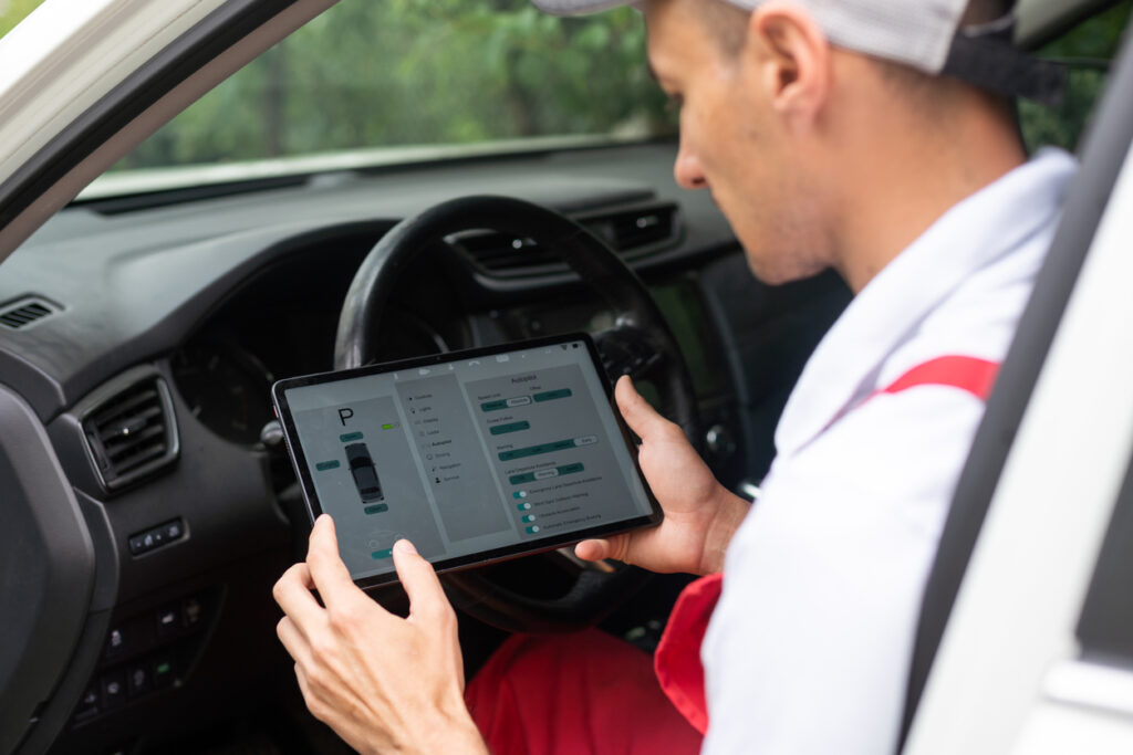 A technician checks a vehicle with augmented reality application in the automotive industry